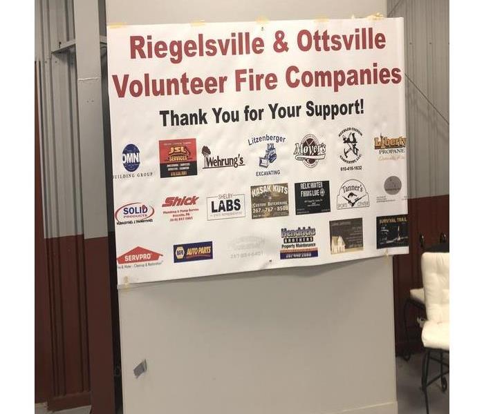 A banner taped up in a fire hall shows businesses that support the Riegelsville & Ottsville Fire Company Bingo